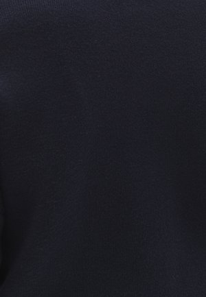 Tessuto lavorato a maglia blu navy, texture liscia, vista ravvicinata che mette in evidenza la superficie uniforme e il colore costante senza motivi o dettagli visibili.