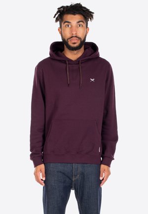 Maroon hoodie made of soft fabric with drawstrings, a front pocket, and a small logo on the chest. Relaxed fit, ribbed cuffs and hem.