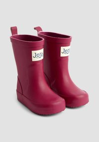 Bottes de pluie en caoutchouc rose avec une surface lisse, un bout arrondi et des languettes à l'arrière. Présente un petit logo blanc sur le côté.
