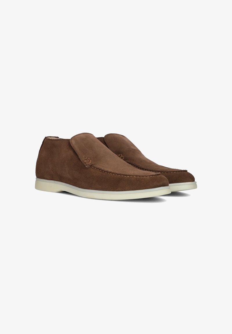 Brown suede slip-on shoes with a rounded toe, stitched details, and a light-colored rubber sole. Features a subtle logo accent on the side.