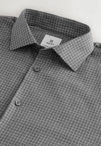 Gray button-up shirt with a checkered pattern, featuring a pointed collar and two gray buttons on the front. Tag labeled "NEXT."