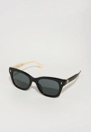Black sunglasses with square lenses, gold accents on temple, and cream-colored tips. Made from plastic with a shiny finish.