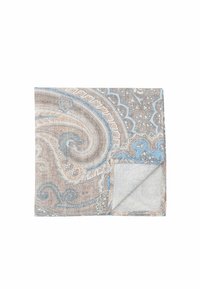 Patterned textile featuring intricate paisley design in beige, blue, and gray. Textured fabric with a folded corner showing a lighter shade.