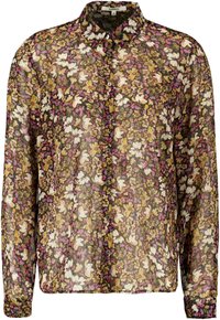 Blusa floreale con tessuto nero trasparente, decorata con fiori bianchi, viola e gialli. Collo classico e chiusura con bottoni frontale, con maniche lunghe.