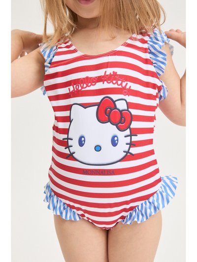Παιδί που φοράει μαγιό Hello Kitty με κόκκινες και λευκές ρίγες, με μπλε και λευκές βολάν στα μανίκια και το τελείωμα, με το όνομα της μάρκας Monnalisa τυπωμένο από κάτω.