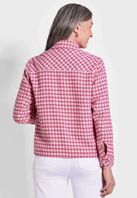 Roze en witte houndstooth gemusterd shirt met lange mouwen en een knoopdetail bij de manchetten. Rechte snit, geschikt voor casual wear.