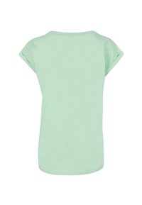 Mintgrøn kortærmet T-shirt med oprullede ærmer, rund halsudskæring og lige kant. Fremstillet af blødt, let stof.