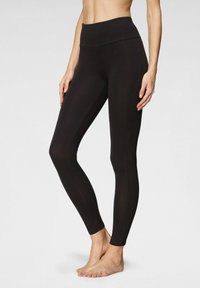 Black leggings with a high, wide waistband, fitted design, smooth texture, and full-length cut, highlighting a streamlined silhouette.