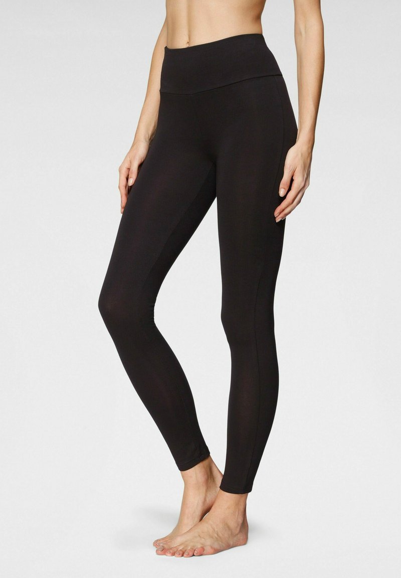 Black leggings with a high, wide waistband, fitted design, smooth texture, and full-length cut, highlighting a streamlined silhouette.