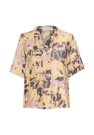 Blouse à manches courtes et col, de couleur jaune pastel avec des motifs abstraits en violet et noir. Fabriquée dans un tissu léger et texturé.