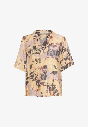 Trumpas rankovėmis, su apykakle, palaidinė šviesiai geltonos spalvos su abstrakčiais purpuriniais ir juodais raštais. Pagaminta iš lengvos, tekstūruotos medžiagos.