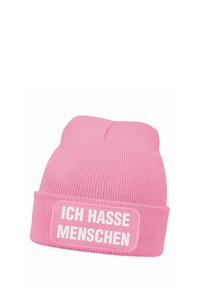 Pink knitted beanie with a folded cuff featuring a rectangular patch that displays the text "ICH HASSE MENSCHEN" in white.