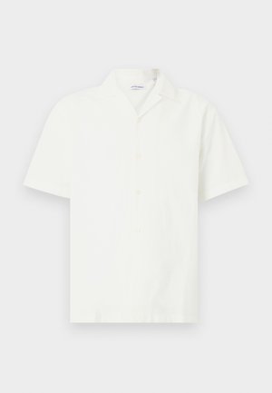 Πουκάμισο με κοντό μανίκι και γιακά σε εκρού χρώμα. Κατασκευασμένο από ελαφρύ ύφασμα με λεία υφή και πέντε κουμπιά στο μπροστινό μέρος.