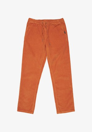 Orangene Baumwollhosen mit einem elastischen Bund, Kordelzugverschluss und seitlichen Taschen. Der Stoff hat eine weiche, strukturierte Oberfläche.