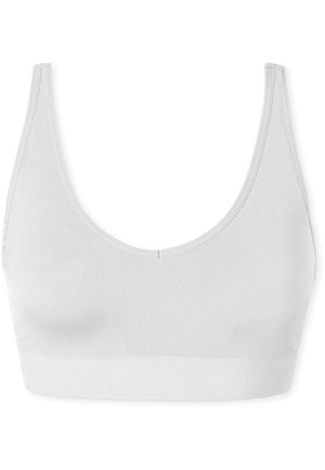 White cotton bralette with a scoop neckline and broad elastic band. Smooth texture and minimal seams feature a simple, seamless design.