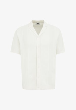 Biezu roku krekls baltā krāsā ar teksturētu rakstu, adīta auduma, un ar iegriezumu apkakli un pogu aizdari priekšā.