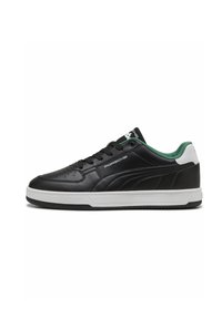 Black leather sneaker featuring a white sole, green accents on the heel, and perforated detail on the vamp. "Porsche" logo on the side.