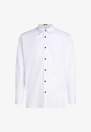 Balta ilgomis rankovėmis marškiniai su apykakle, priekyje užsegami juodais mygtukais ir su viena krūtine kišene. Lygus audinys su struktūrizuotu siluetu.