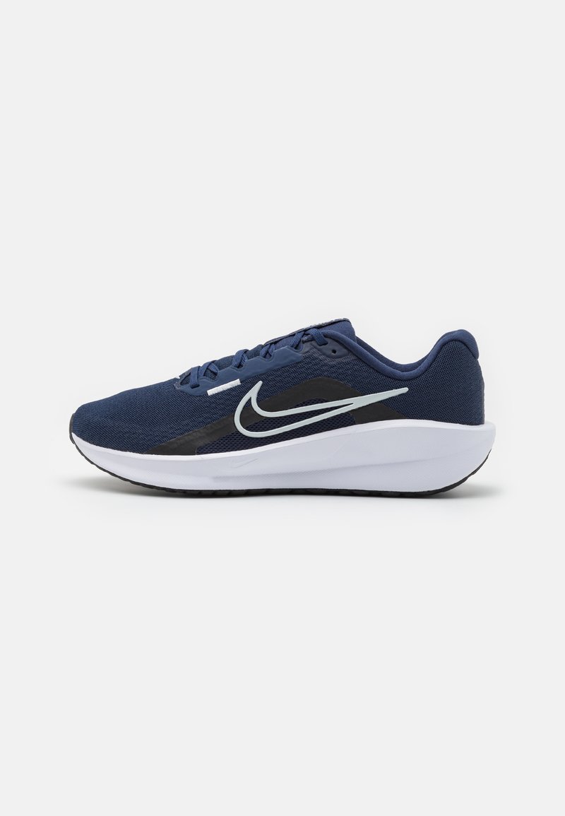 Navy blue athletic shoe with a mesh upper, gray Nike swoosh, black accents, and white sole. Features lace closure and textured outsole.