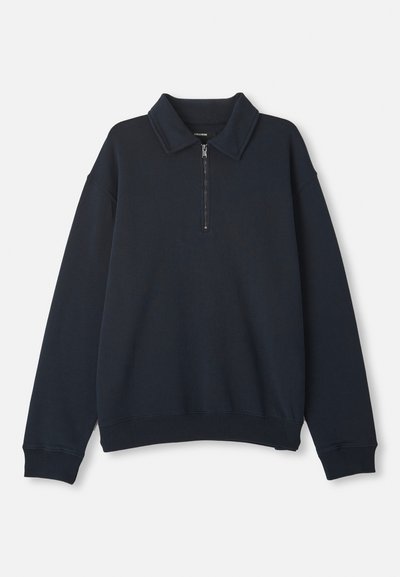 Navy blue long-sleeve pullover with a half-zip front and pointed collar, ribbed cuffs and hem.