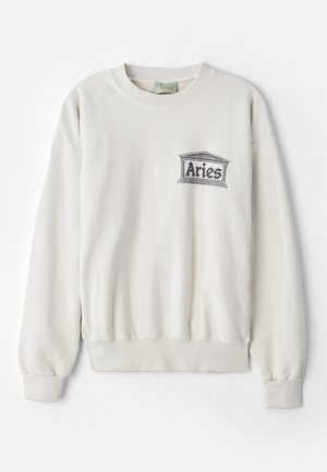Cream-colored sweatshirt made of soft fabric, featuring a rounded neckline and ribbed cuffs. It has a printed "Aries" logo in gray.