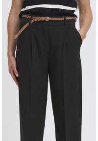 Black tailored trousers with pleats, featuring a braided tan leather belt and side pockets, set against a plain white background.