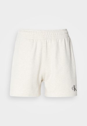 Shorts en coton gris clair avec une taille élastique, présentant une texture lisse et un petit logo noir sur le bas à droite.