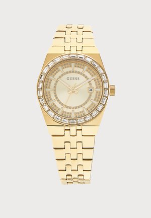 Ръчен часовник Gold Guess със заобикаляща се рамка с кристали, златен циферблат, три стрелки, прозорец за дата и каишка с връзки.