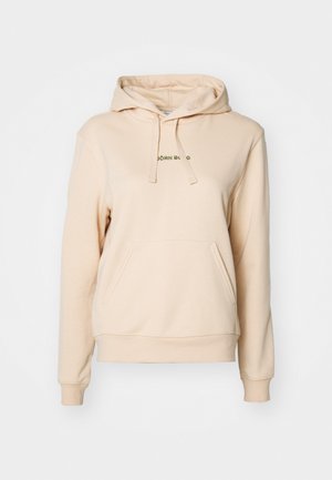 Beige hooded sweatshirt made of soft fabric with a front pocket. Features drawstring hood and green text on the chest.