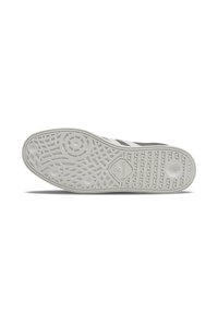Shoe sole with a textured white rubber surface, features circular and linear patterns, labeled with a logo, designed for grip and durability.