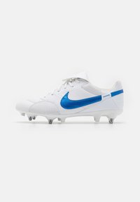 Valged jalgpallijalatsid suure sinise Nike swooshiga, tekstuuriga paneelid ja vormitud nupud välisküljel haarde tagamiseks. "Premier" detail kandadel.