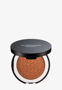 Bronzer BareMinerals in un compact rotondo. Coperchio nero con logo bianco; polvere bronzante testurizzata con le iniziali del marchio in rilievo all'interno.