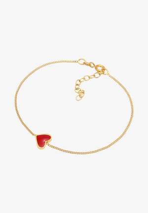 Zelta ķēdes aproce ar nelielu sarkanu sirds piekariņu. Ķēde ir ar smalku, pītā tekstūra un regulējams aizdare, lai nodrošinātu piemērotību.