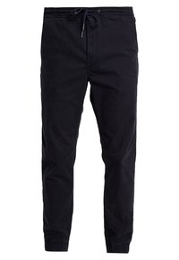 Mustat rentojogger-housut, joissa on joustava vyötärö, nyöri, sivutaskut ja joustavat hihnat.