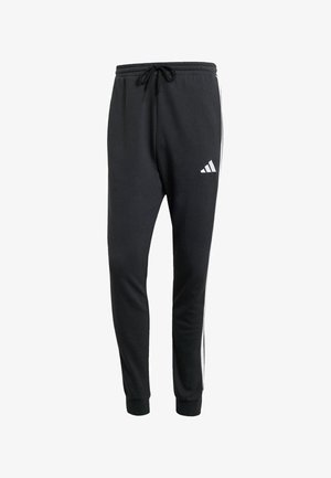Black sweatpants made from soft fabric, featuring a drawstring waist, side white stripes, and the Adidas logo in white on the left leg.