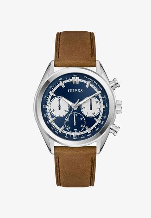 Montre chronographe avec un cadran bleu marine, un boîtier en acier inoxydable argenté, trois sous-cadrans et un bracelet en cuir marron avec une finition texturée.