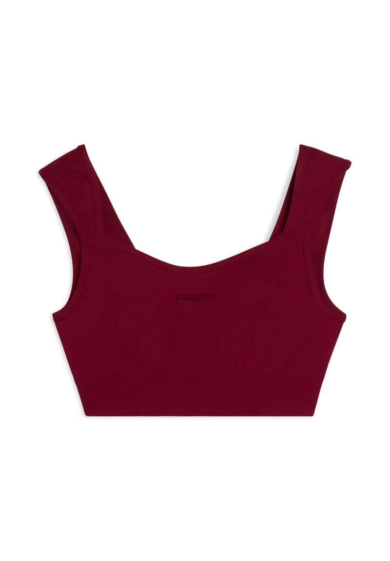 Top corto bordeaux con spalline larghe, design senza cuciture e logo embossato discreto. Realizzato in tessuto liscio ed elastico, presenta una silhouette aderente.