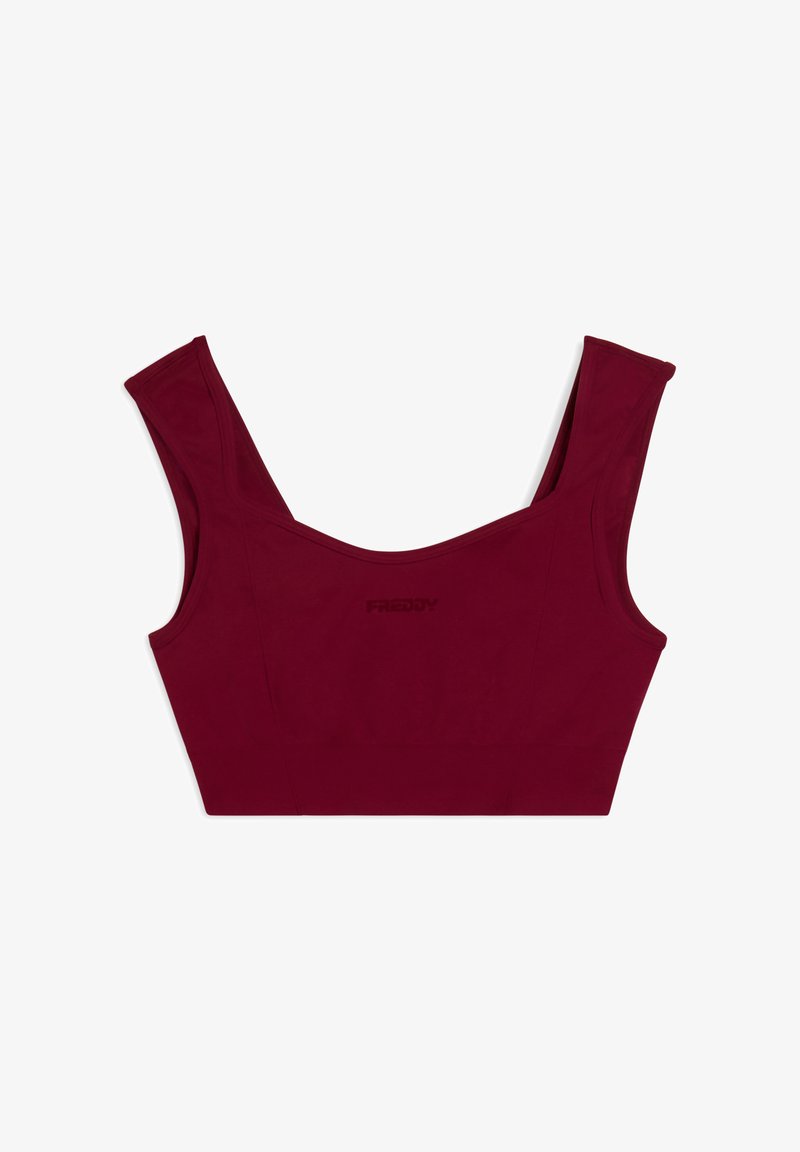 Top corto burdeos con tirantes anchos, diseño sin costuras y logo embellecido sutilmente. Fabricado con una tela suave y elástica, que presenta una silueta ajustada.