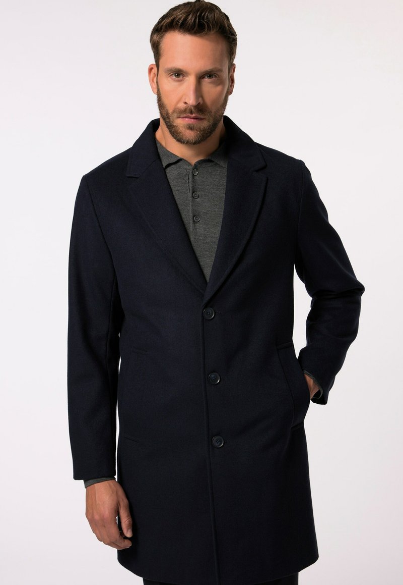 Cappotto in misto lana color navy con colletto a punte, chiusura con bottoni a un solo petto, tasche laterali e una superficie liscia e testurizzata.