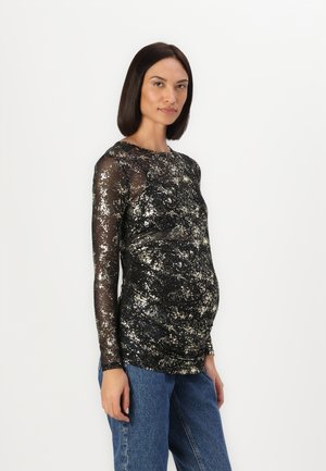 Svart og gull langermet topp med en gjennomsiktig tekstur, som har et spraglete mønster og en tettsittende design som fremhever en rund midje.