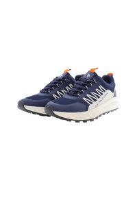 Navy athletic shoes with textured mesh, orange accents, and a thick white sole. Features bold white stripes and a rugged black outsole.