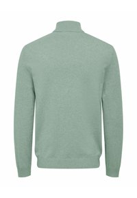 Lichtgroene gebreide pullover met een hoge kraag, lange mouwen en geribbelde manchetten en zoom. Gladde textuur en effen kleur, zonder patronen of accenten.