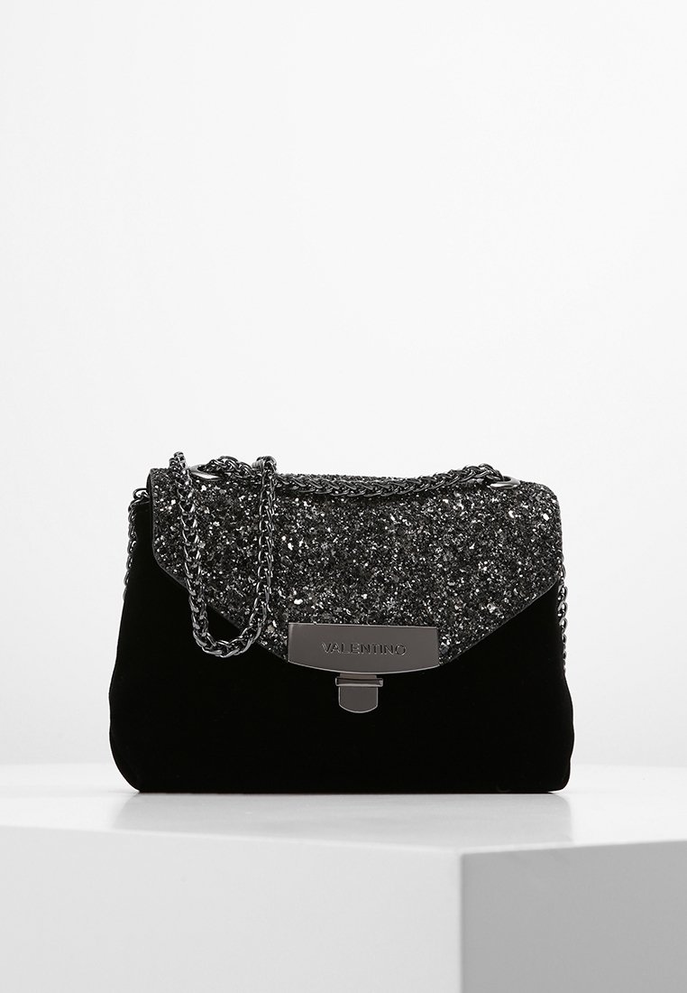 Borsa a mano in velluto nero con un flap superiore luccicante, hardware argento e una tracolla a catena, offrendo una forma rettangolare compatta.