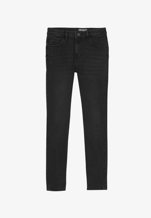 Jean noir slim avec fermeture à boutons, passants pour ceinture, poches avant et poche monnaie, avec étiquette visible "ERNEST" à l'intérieur de la ceinture.