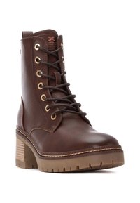 Botas de tobillo de cuero marrón con ojales dorados, cordones redondos, tacón grueso y acentos laterales texturizados. Suela de goma gruesa y con tracción para un buen agarre.