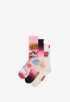 Trois paires de chaussettes de maintien : rose avec un design de bande dessinée, bleu marine rayé avec des blocs de couleur, et crème avec un graphique de cœur. Tissu en maille doux, motifs variés.