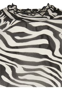 Zebra-mönstrad topp med ett tunt, lätt tyg i svart och vitt, volangkant i halsringningen och en avslappnad passform.