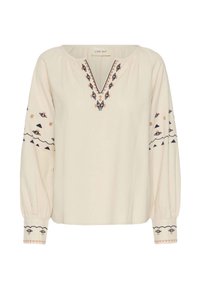 Blouse crème à manches longues avec un décolleté en V, des motifs brodés en bleu marine et pêche, des poignets élastiques et une coupe décontractée.