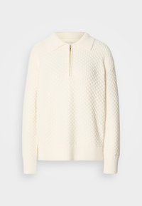 Pullover bianco a maglia con un motivo testurizzato, mezzo zip e colletto e polsini a coste. Il materiale sembra morbido e accogliente.