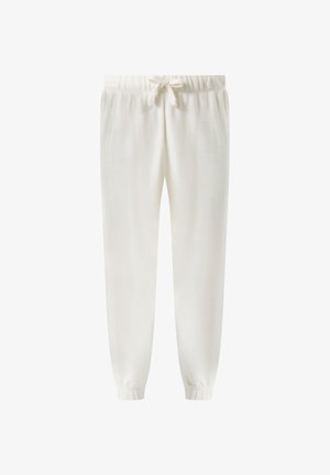 Białe spodnie dresowe z elastycznym pasem z gumką i sznurkiem do wiązania oraz elastycznymi ściągaczami przy nogawkach, zaprojektowane do codziennego noszenia.